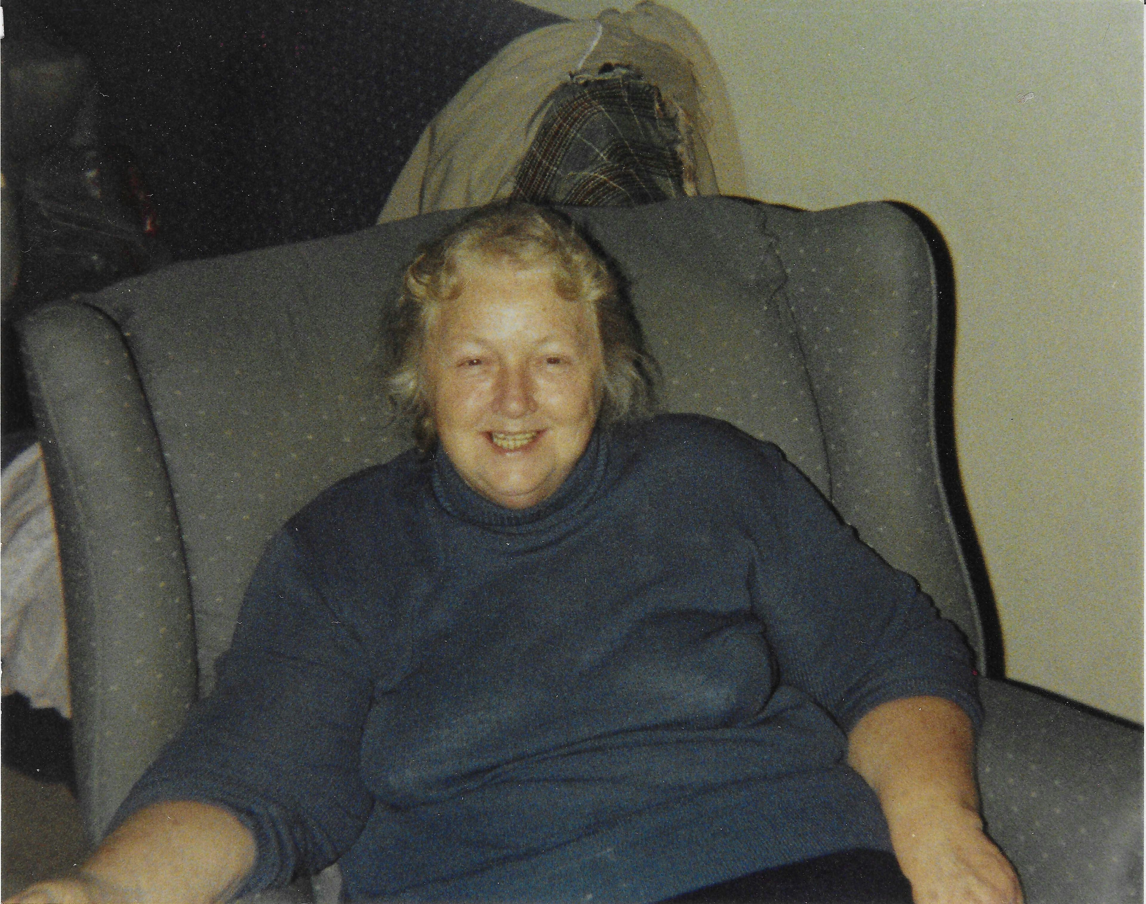 Cheerful woman with blonde hair in comfortable home setting